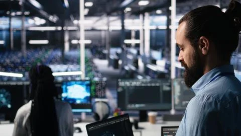 Close up of developer in data center coding with generative AI on laptop Stock Photos