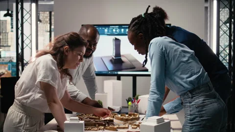 Close up of developers arranging 3D models to explore residential layout Stock Footage 316795830