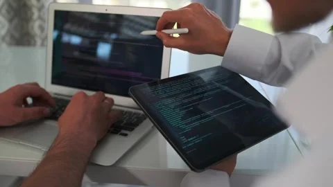 Close up of developers collaborating, coding, and reviewing Stock Footage 294298844