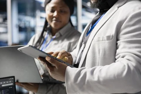Close up of developers in data center using tablet to update infrastructure 스톡 사진