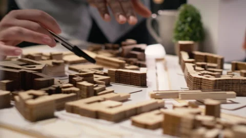Close up of developers work together on layout city planning initiative Stock Footage 316642720