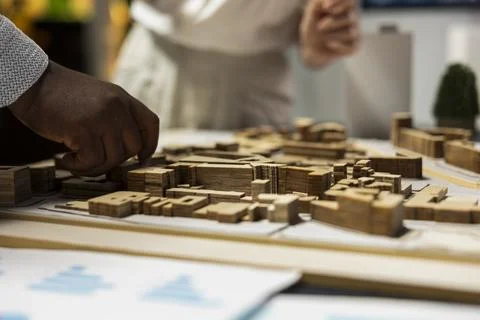 Close up of developers work together on layout city planning initiative Stock Photos