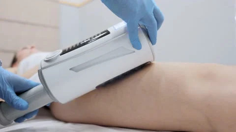 Close-up of the device massaging the buttocks and legs of a young woman. The Stock-Footage 230183676