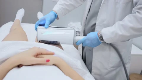 Close-up of the device massaging the buttocks and legs of a young woman. The Stock-Footage 231696517