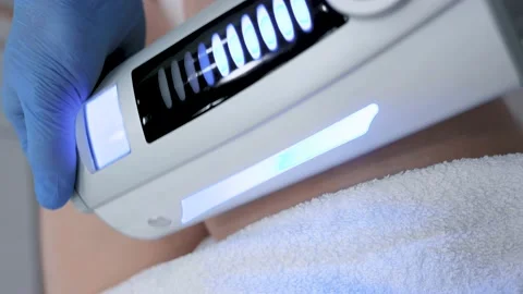 Close-up of the device massaging the buttocks and legs of a young woman. The Stock-Footage 232596302