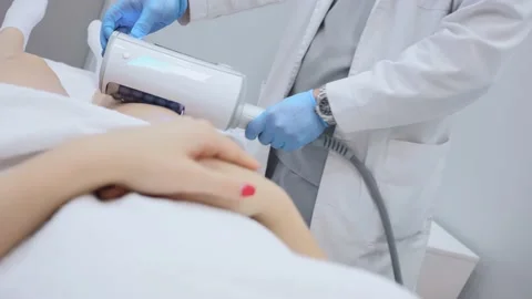 Close-up of the device massaging the buttocks and legs of a young woman. The Stock-Footage 232596339