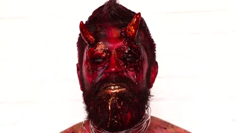 Close up devil Halloween face. Devil head with horns in blood bloody face. Scary Stock Footage 141423283