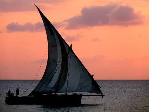 Close up of dhow sailing gracefully by at sunset, Zanzibar Stock Photos