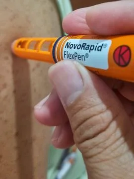 Close-up of a diabetic patient using insulin pen for making an insulin injection Stock Photos