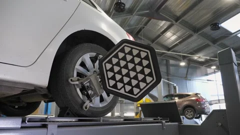 Close-up diagnostics and balancing of wheels on a lift at a service station. Stock Footage 337733724