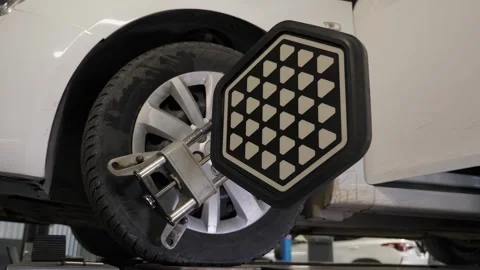 Close-up diagnostics and balancing of wheels on a lift at a service station. Stock Footage 338995814