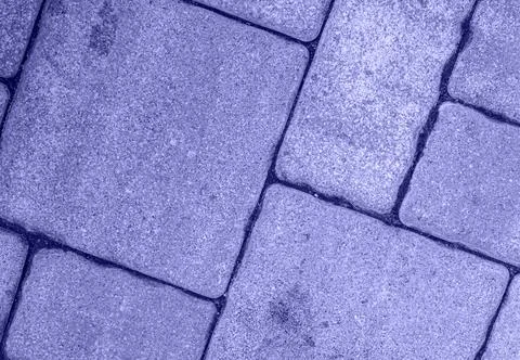 Close up of diagonal street pavement pattern toned in very peri color Foto stock