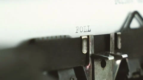 Close up diagonal view typing text " follow us " on a old typewriter Stock Footage 149347702