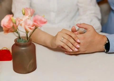Close-up diamond ring proposal couple holding hands Stock Photos