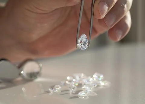 Close up of diamonds in the evaluating process at expert workplace. Stock Photos