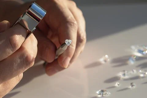 Close up of diamonds in the evaluating process at expert workplace. Stock Photos