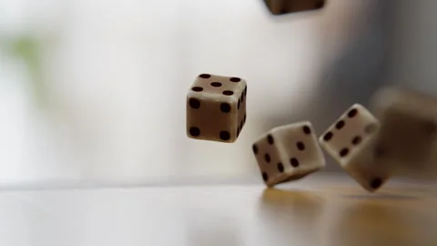 Close up of Dice cubes falling on a wooden table in the kitchen Stock Footage 253559033