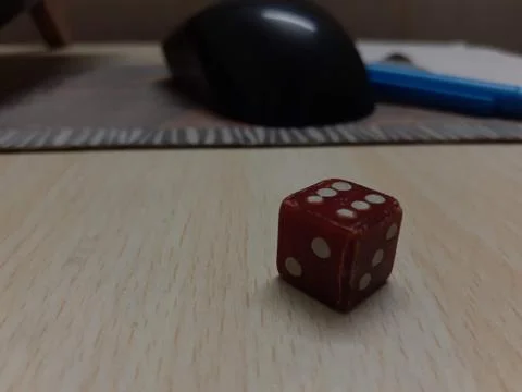 A close up of a dice on a table Stock Photos