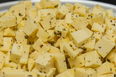 Close up of diced cheese to be served at party. Cheese seasoned with oregano, Stock Photos