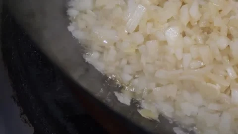 Close-Up of Diced White Onions Sautéing in a Pot Stock Footage 332814525