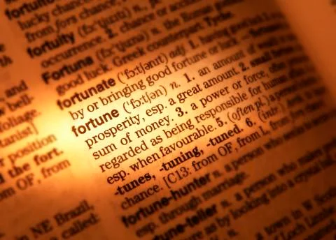CLOSE UP OF DICTIONARY PAGE SHOWING DEFINITION OF THE WORD FORTUNE Stock Photos