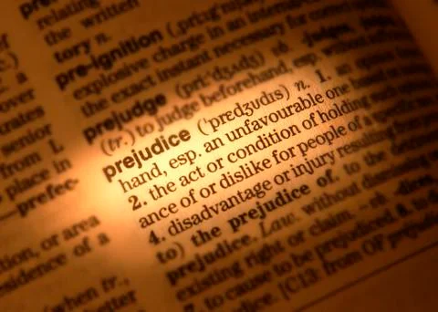 CLOSE UP OF DICTIONARY PAGE SHOWING DEFINITION OF THE WORD PREJUDICE Stock Photos