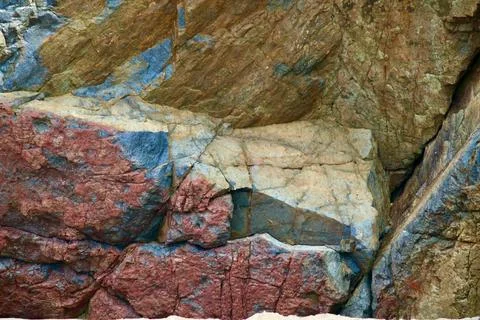 Close up of different coloured rocks on a cliff face Stock Photos