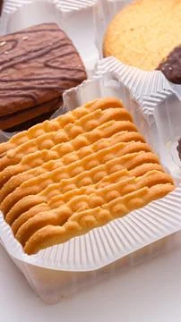 Close-up of different cookies and biscuits neatly arranged in a plastic conta Foto stock