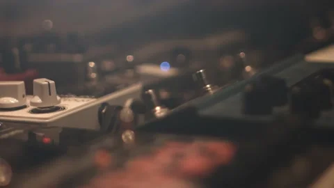 Close up of different guitar pedal effect stomp boxes on the floor in a Stock-Footage 143383771