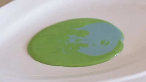 Close-up of different shades of paint being mixed in bowl Stock Footage 130912643