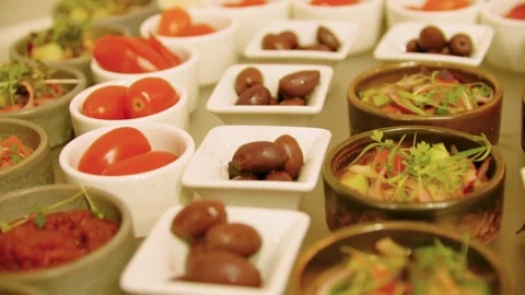 Close-up of different types of appetizers in small bowls on a buffet table. Stock Footage 300434199