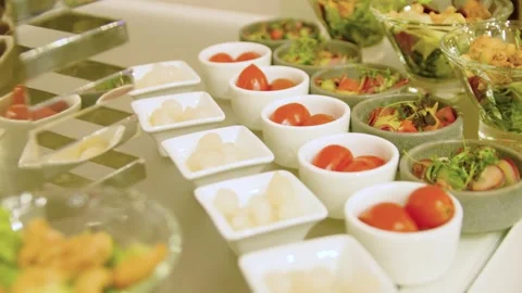 Close-up of different types of appetizers in small bowls on a buffet table. Stock-Footage 300434271