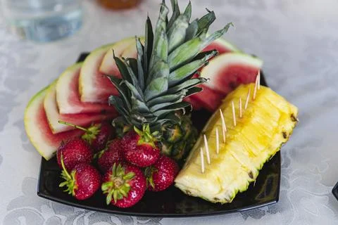 Close up of different types of fruit on a black plate Stock Photos