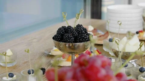 Close-up of different types of fruits, cheese and canapes on a buffet table. Stock Footage 285038360