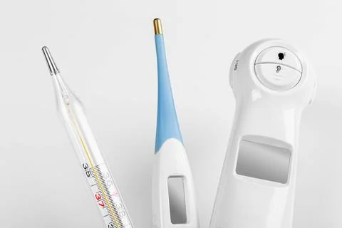 Close-up of different types of thermometers for measuring the body temperatur Stock Photos