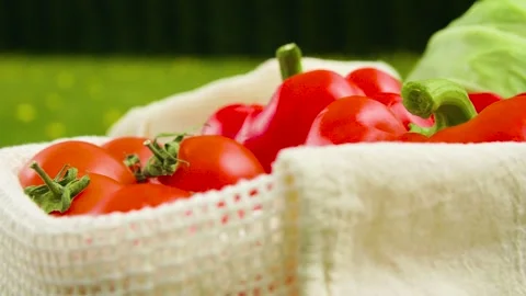 Close-up of different types of vegetables in fabric bags on a wooden table. Stock Footage 276232942