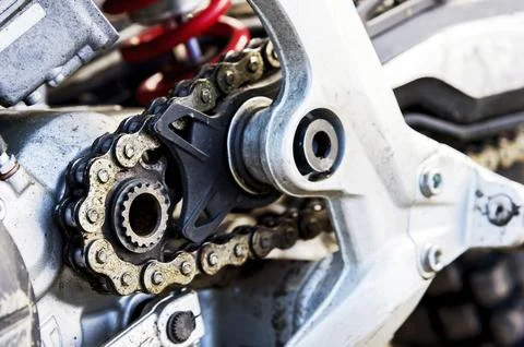 Close-up of a digger with an asterisk and a chain of a trial motorcycle Stock Photos