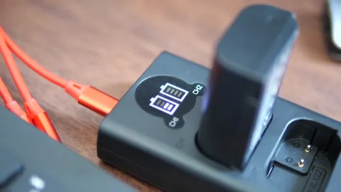 Close-up of digital camera battery charging on dual charger Video stock 332421789