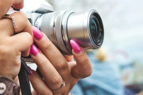 Close-up of a digital camera being used by a woman with painted fingernails Stock Photos