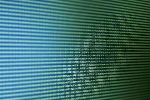 Close-up of a digital display featuring binary code in blue and green tones, Foto stock