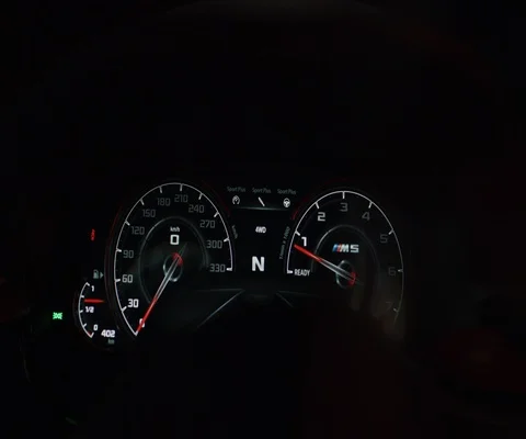 Close up of digital light up speedometer speeding up on dark background Stock Footage 147040493