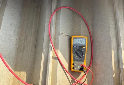 Close-up of a digital multimeter measuring DC voltage output from a photovolt Stock Photos