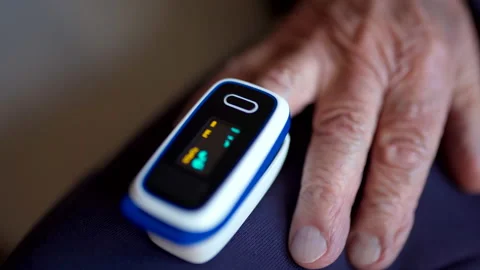 Close-up of digital pulse oximeter, senior adult controls oxygen rate in blood Stock Footage 144626187