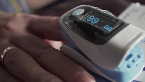 Close up of digital pulse oximeter on woman's finger, medical monitoring device  Stock Footage 164110745