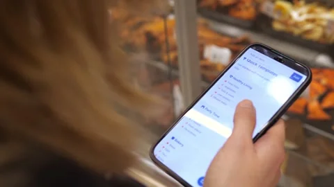 Close-up of a digital shopping list for various occasions on a phone screen Stock Footage 316584769