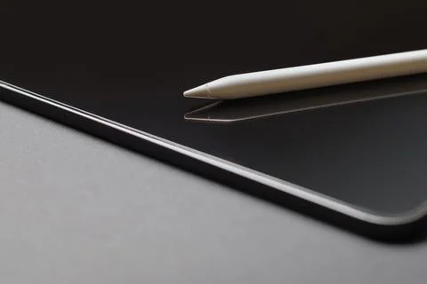 Close-up of digital tablet and pencil on grey background Stock Photos