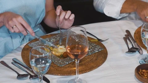 Close up of dinner table, woman having salad and wine 動画素材 81645847