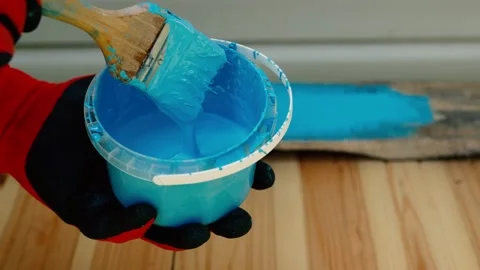 Close up of dipping brush into blue paint outside. Home renovation. Blue paint Stock Footage 201266360