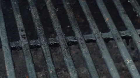 Close-Up of Dirty, Hot Grill Grates Heating Up During Summertime Stock Footage 313713607