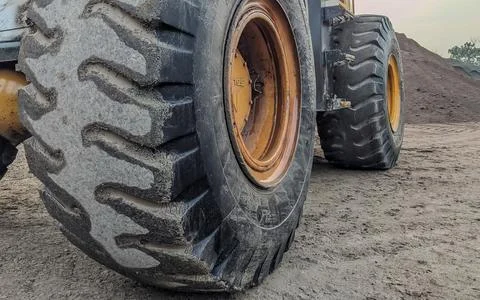Close-up of a dirty loader wheel with a large tread, Stock Photos